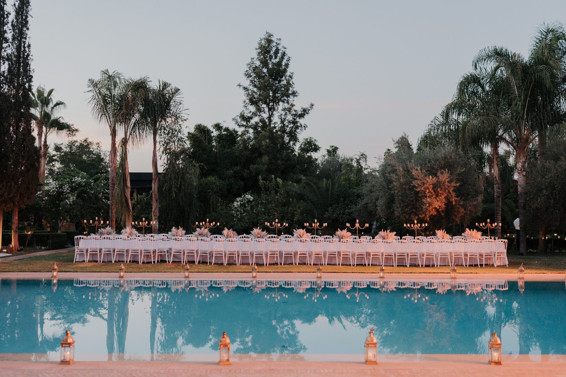 Une table de mariage pres de la piscine en décoration de mariage
